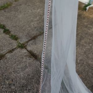 Cathedral length ivory wedding veil with rose gold beading